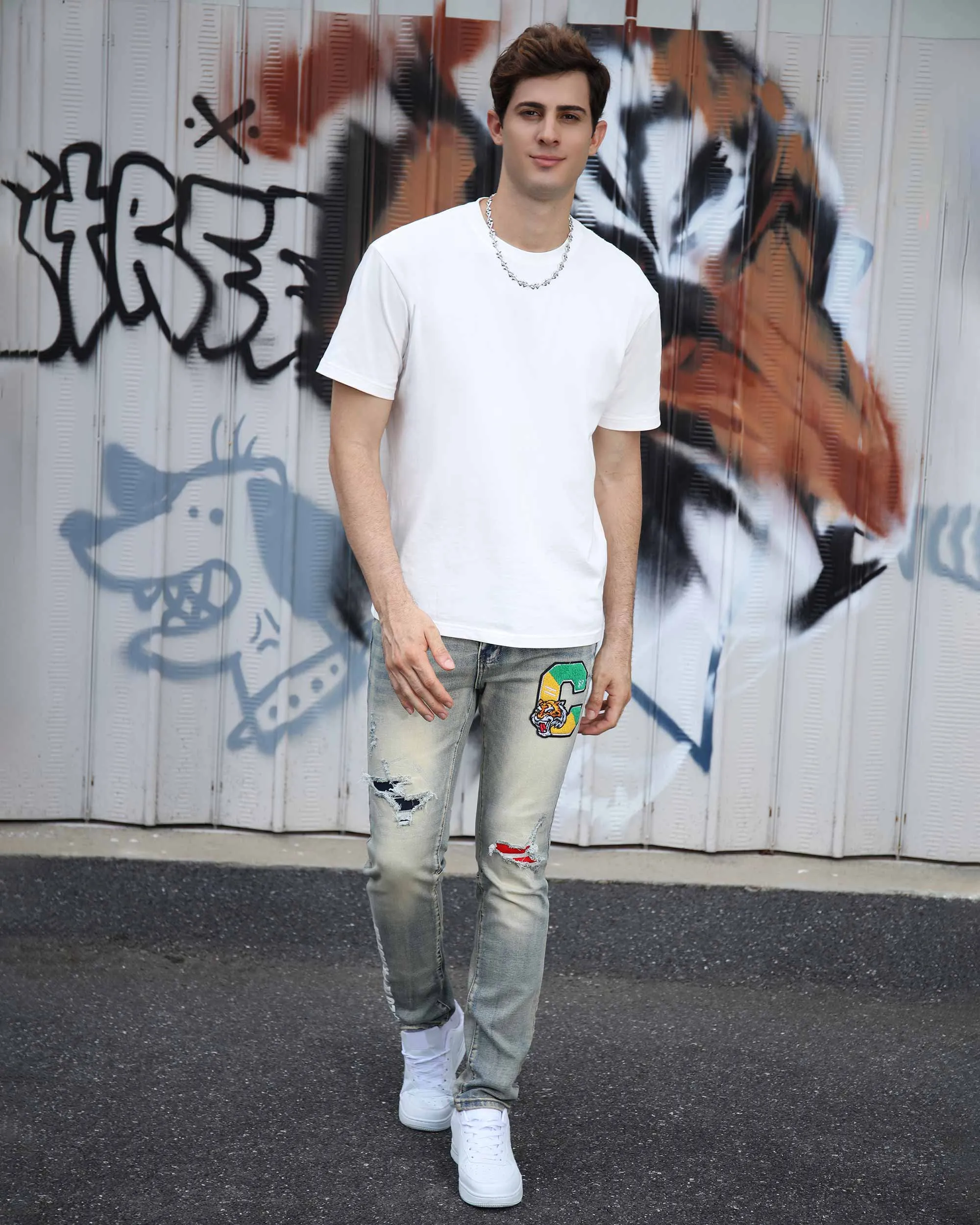 Distressed Light Wash Blue Ripped Jeans with Lion Motif Embroider
