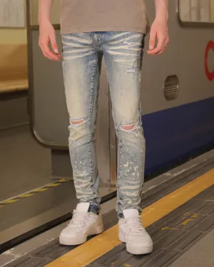 Distressed Whiskered Blue Ripped Jeans with Spray Paint Accents