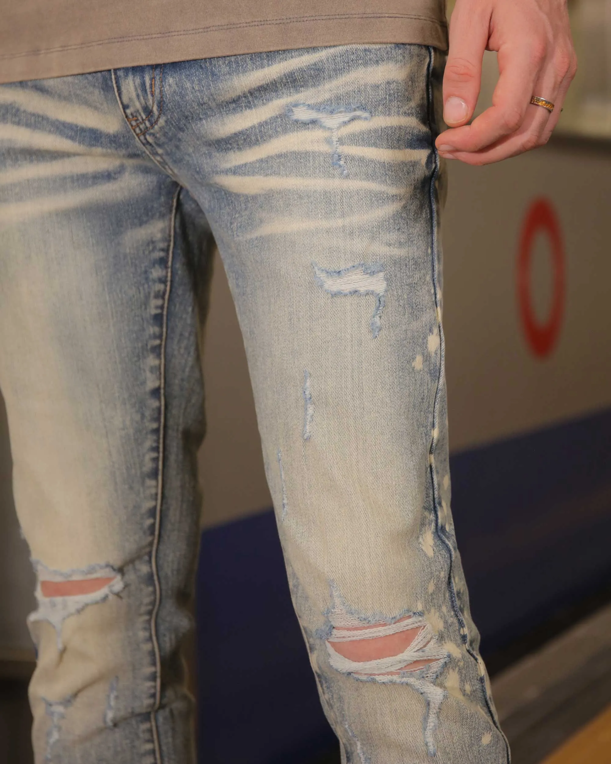 Distressed Whiskered Blue Ripped Jeans with Spray Paint Accents
